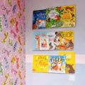 Clear acrylic kids bookshelves wall mounted in a children's bedroom